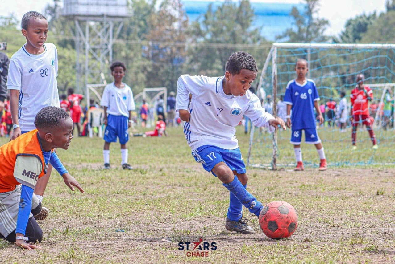 Young striker striking the ball with power during competitive tournament match