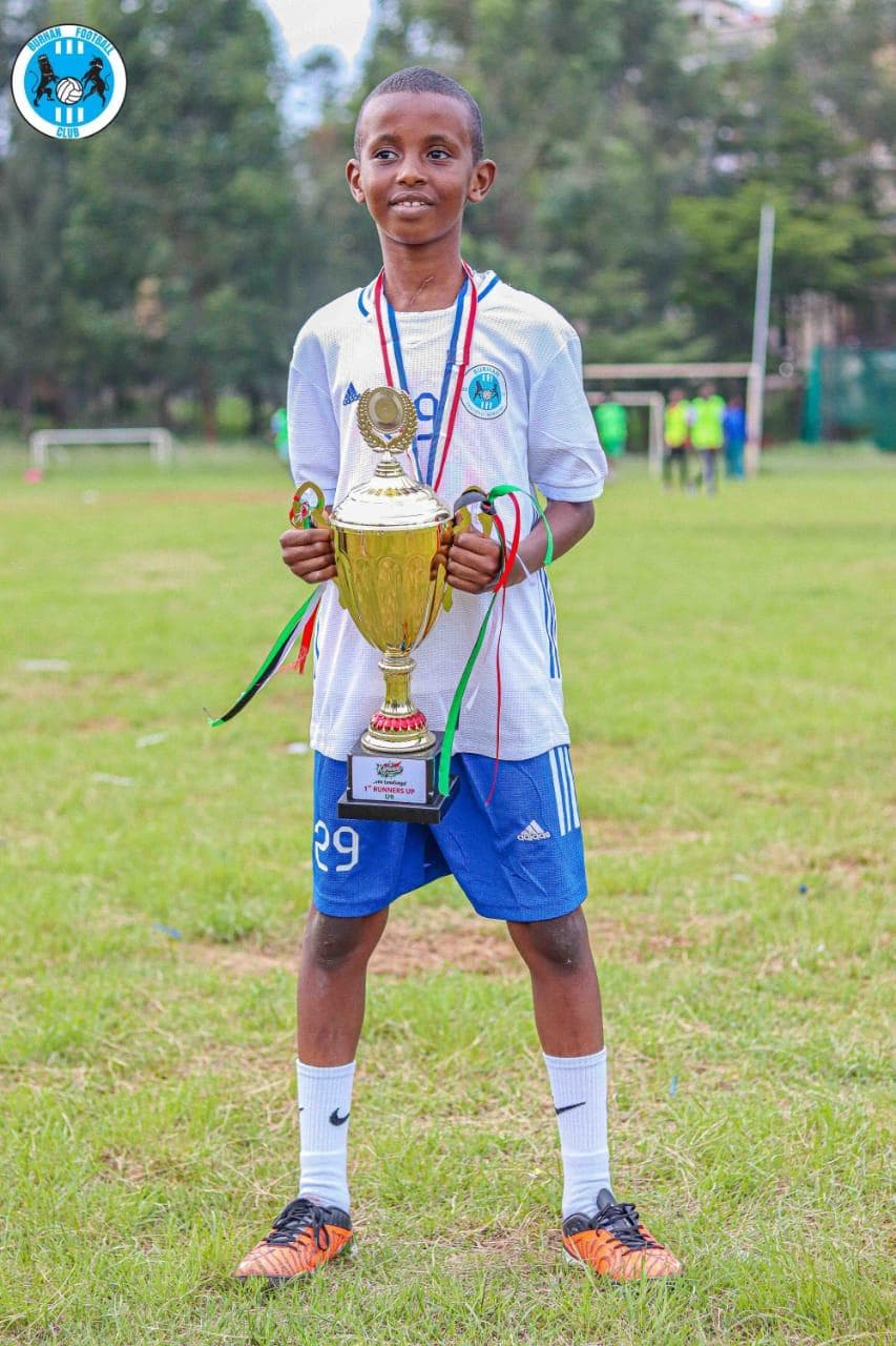Burhan Academy squad with medals on the championship podium